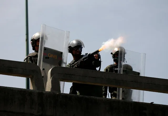 The national guard fires a tear gas canister to disperse demonstrators during clashes with security forces during an opposition rally in Caracas, Venezuela on April 4, 2017. (Photo by Carlos Garcia Rawlins/Reuters)