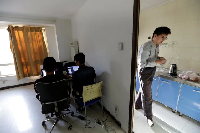 Wu Yaxiong (R), CEO of N-Wei (Beijing) Technology Company Limited, fetches water at a kitchen at an apartment that he rents as an office and employees' dormitory, in Beijing, China, April 22, 2016. (Photo by Jason Lee/Reuters)
