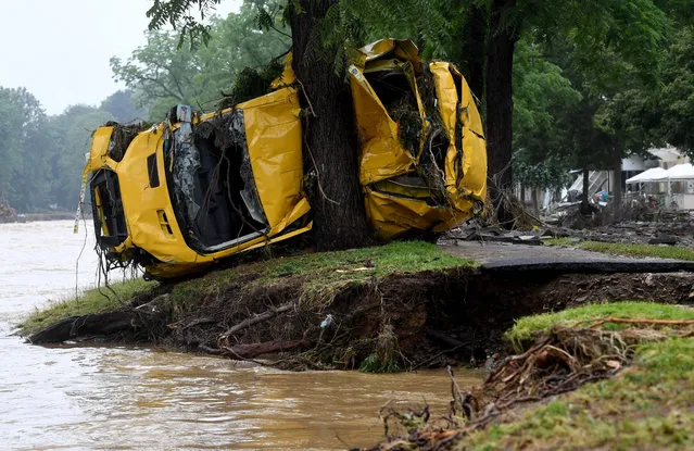 A van crushed by the torrents is pressed against a tree after the floods caused major damage in Bad Neuenahr-Ahrweiler, western Germany, on July 16, 2021. The death toll from devastating floods in Europe soared to at least 93, most of them in western Germany, where emergency responders were searching for hundreds of missing people. (Photo by Christof Stache/AFP Photo)