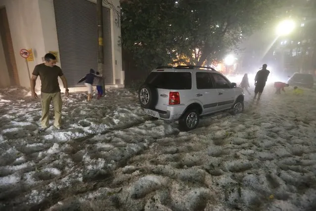 Ice is seen covering a street after a hailstorm in Sao Paulo, Brazil, on May 18, 2014. (Photo by Nilton Fukuda/AP Photo)