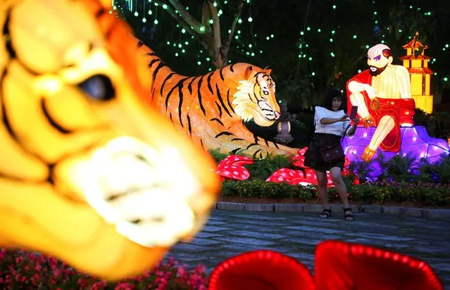 A woman takes a selfie with Chinese Lunar New Year decorations at Fo Guang Shan Dong Zen Buddhist Temple in Jenjarom, Malaysia, January 28, 2022. (Photo by Hasnoor Hussain/Reuters)