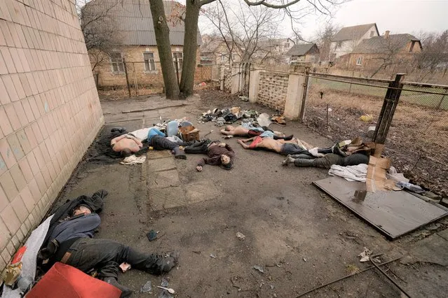 Lifeless bodies of men, some with their hands tied behind their backs lie on the ground in Bucha, Ukraine, Sunday, April 3, 2022. Associated Press journalists in Bucha, a small city northwest of Kyiv, saw the bodies of at least nine people in civilian clothes who appeared to have been killed at close range. At least two had their hands tied behind their backs. (Photo by Vadim Ghirda/AP Photo)