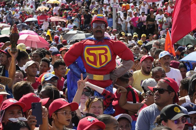 A supporter dressed as “Super Bigote”, a cartoon character depicting Venezuela's President Nicolas Maduro as a superhero, stands above the crowd during a campaign rally, ahead of the upcoming presidential election  in Caracas, Venezuela, July 18, 2024. (Photo by Ariana Cubillos/AP Photo)