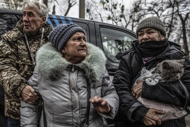 Tatyana Symenonko, 68, clutched her British shorthaired gray cat in a plastic bag to her chest as she arrived with others who fled the city of Irpin through a safe corridor into Kyiv, Ukraine, on March 27,2022. (Photo by Heidi Levine for The Washington Post)