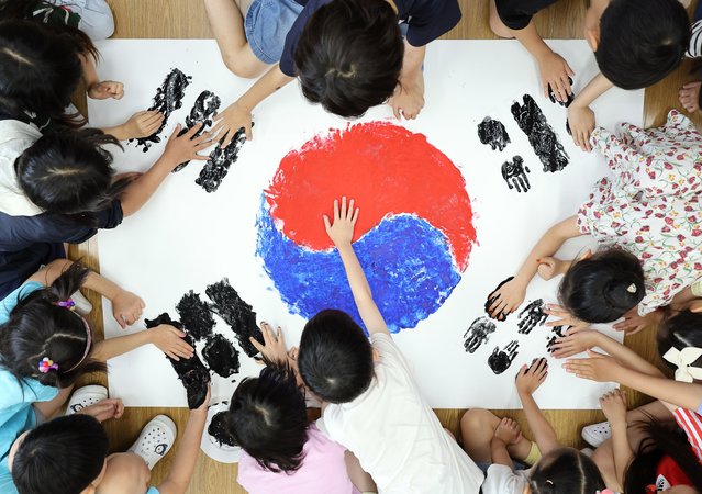 Students make the national flag using their handprints at Youngduk Elementary School in Suwon, South Korea, 17 July 2024, on the occasion of the 76th anniversary of Constitution Day. (Photo by Yonhap/EPA)