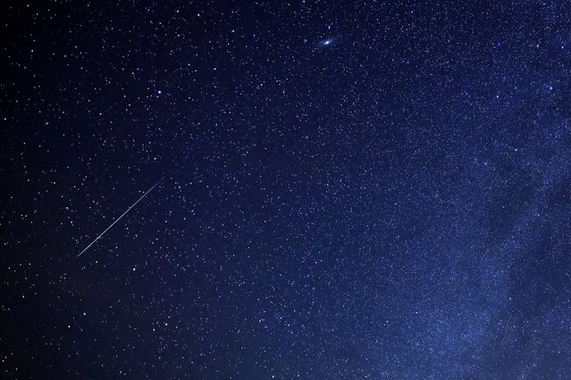 A meteor burns up in the sky over al-Abrak desert north of Kuwait City during the annual Geminid meteor shower early on December 15, 2023. (Photo by Yasser Al-Zayyat/AFP Photo)