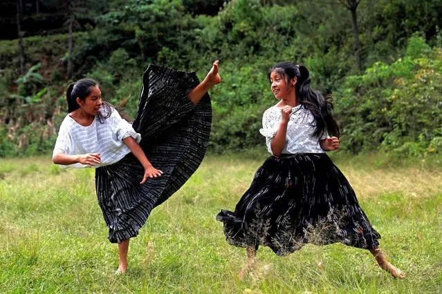 Indigenous Q'eqchi girls practice taekwondo with their teacher, Danny Coy, on a dirt court in the middle of the village in Tipulcan village, San Pedro Carcha, Guatemala, on 25 November 2019 (issued 27 November 2019). Tipulcan village girls learn taekwondo to combat sexist violence and harassment they have suffered in their community in northern Guatemala. (Photo by Esteban Biba/EPA/EFE)