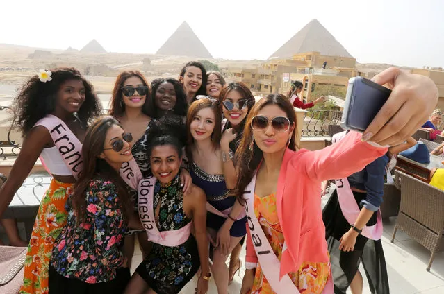 Contestants of Miss ECO Universe take a selfie with pyramids behind, on the outskirts of Cairo, Egypt, April 10, 2016. (Photo by Mohamed Abd El Ghany/Reuters)