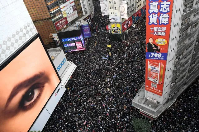People attend a Human Rights Day march in the district of Causeway Bay in Hong Kong, China on December 8, 2019. (Photo by Laurel Chor/Reuters)