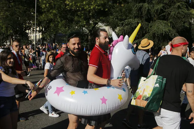 Participants take part during the Gay Pride demonstration and parade, the climax of the 10-day WorldPride festivities, in Madrid, Spain, Saturday, July 1, 2017. Hundreds of thousands of people are marching in a global gay pride demonstration in Madrid under tight security measures on Saturday. (Photo by Paul White/AP Photo)