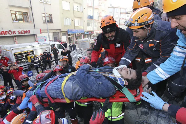 Rescue workers carry a wounded man that was found alive in the rubble of a building destroyed on Friday's earthquake in Elazig, eastern Turkey, Saturday, January 25, 2020. Rescue workers were continuing to search for people buried under the rubble of apartment blocks in Elazig and neighboring Malatya. Mosques, schools, sports halls and student dormitories were opened for hundreds who left their homes after the quake. (Photo by Depo Photos via AP Photo)