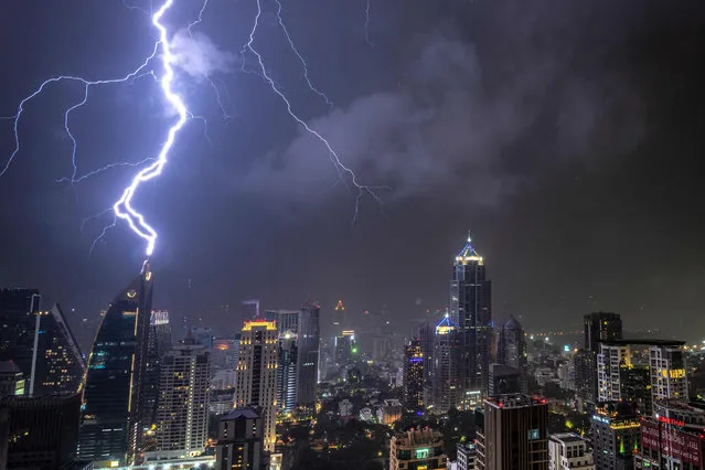 In this picture taken on October 27, 2019 lightening strikes on a building during a thunderstorm in Bangkok. (Photo by Mladen Antonov/AFP Photo)