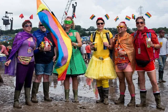 Festival goers cope with muddy conditions on day 2 of the Glastonbury Festival at Worthy Farm, Pilton on June 25, 2016 in Glastonbury, England. Now in its 46th year the festival is one largest music festivals in the world and this year features headline acts Muse, Adele and Coldplay. The Festival, which Michael Eavis started in 1970 when several hundred hippies paid just £1, now attracts more than 175,000 people. (Photo by Ian Gavan/Getty Images)