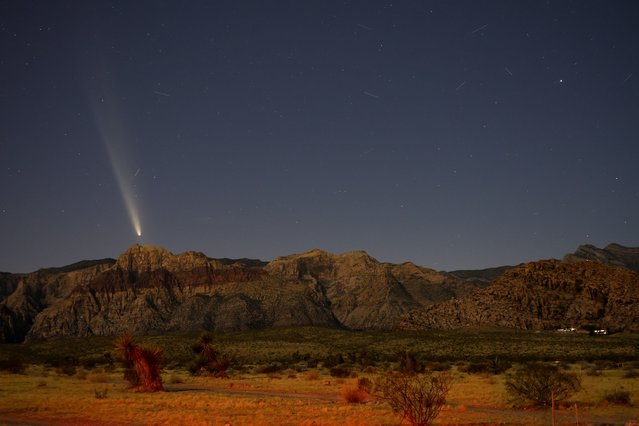 Comet C/2023 A3 (Tsuchinshan-ATLAS) appears in the western sky shortly after sunset above rock formations in the Red Rock Canyon National Conservation Area on October 13, 2024 in Las Vegas, Nevada. The comet, also known as Comet A3, is about 44 million miles from Earth and likely originated from the Oort Cloud. It last passed Earth 80,000 years ago. (Photo by Ethan Miller/Getty Images)