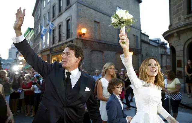Parti Quebecois leader Pierre Karl Peladeau and his wife Julie Snyder wave to the crowd after their wedding at the Musee de l'Amerique Francophone in Quebec City, August 15, 2015. (Photo by Mathieu Belanger/Reuters)
