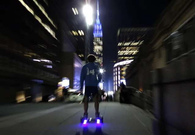 In this October 21, 2015, file photo, a young man rides a hoverboard along a Manhattan street toward the Empire State Building in New York. More than 500,000 hoverboards are being recalled after reports that they can burst into flames. The Consumer Product Safety Commission said Wednesday, July 6, 2016, it has received 99 reports of battery packs in the two-wheel motorized scooters catching fire or exploding that causing burns or property damage. The recalled hoverboards were made by eight companies. (Photo by Kathy Willens/AP Photo)