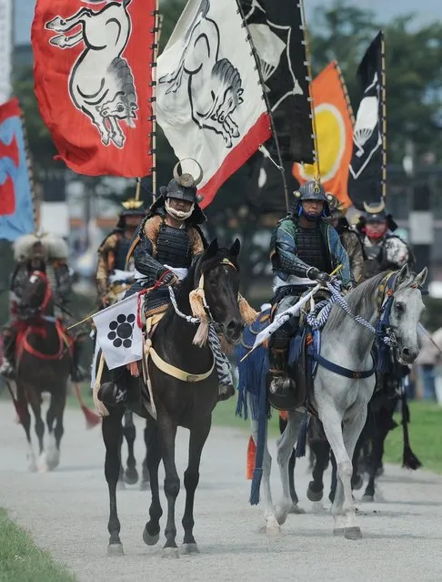 Local people in samurai armor ride their horses during a parade at the annual Soma Nomaoi Festival in Minamisoma, Fukushima Prefecture, on July 29, 2012. Some 400 horses and thousands of people took part in the 1,000-year-old “Soma Nomaoi”, or wild horse chase, at the weekend in the shadow of Japan's crippled Fukushima nuclear plant. (Photo by Toru Yamanaka/AFP Photo)