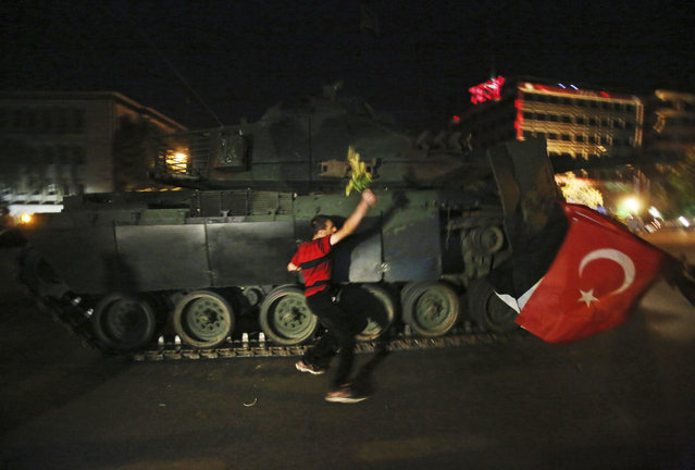 A tank moves into position as Turkish people attempt to stop them, in Ankara, Turkey, early Saturday, July 16, 2016. Members of Turkey's armed forces said they had taken control of the country Friday as explosions, gunfire and a reported air battle between loyalist forces and coup supporters erupted in the capital. President Erdogan remained defiant and called on people to take to the streets to show support for his embattled government. (Photo by AP Photo)