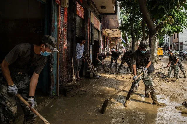 Soldiers clean the road at Bandong Town on July 12, 2016 in Fuijan, China. Typhoon Nepartak hit China's coastal southeastern Fujian province over the weekend, killing at least nine people and forced relocation for least 420,000 people in four cities, according to reports. (Photo by Lam Yik Fei/Getty Images)