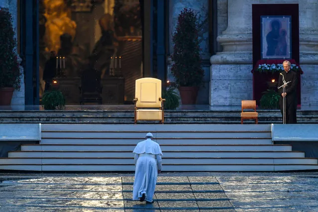 Pope Francis walks towards the platform to preside over a moment of prayer on the sagrato of St Peter’s Basilica, the platform at the top of the steps immediately in front of the façade of the Church, to be concluded with the Pope giving the Urbi et orbi Blessing, on March 27, 2020 at the Vatican. (Photo by Vincenzo Pinto/AFP Photo)