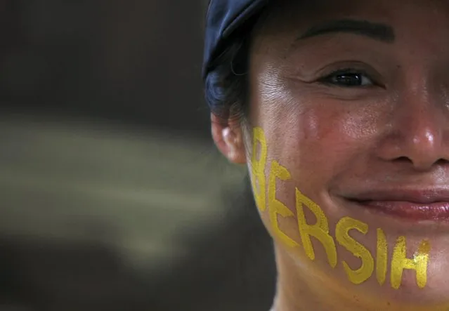 A supporter of pro-democracy group “Bersih” (Clean) with her face painted takes part in a rally in Malaysia's capital city of Kuala Lumpur August 30, 2015. (Photo by Edgar Su/Reuters)
