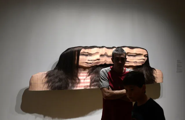 Visitors stand in front of the sculpture “Panagiota: Conversation 1, Variation 2” by South African artist Evan Penny, at the Hyperrealist Sculpture 1973-2016 exhibition in the Museum of Bellas Artes in Bilbao, northern Spain, July 27, 2016. (Photo by Vincent West/Reuters)