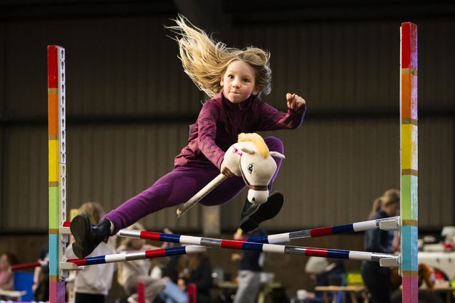 Mane flowing, a young competitor clears a jump at the hobby horse racing, eventing and dressage event at Parklands Equestrian Centre near Sheffield, UK on December 30, 2024. (Photo by James Glossop/Times Media Ltd)