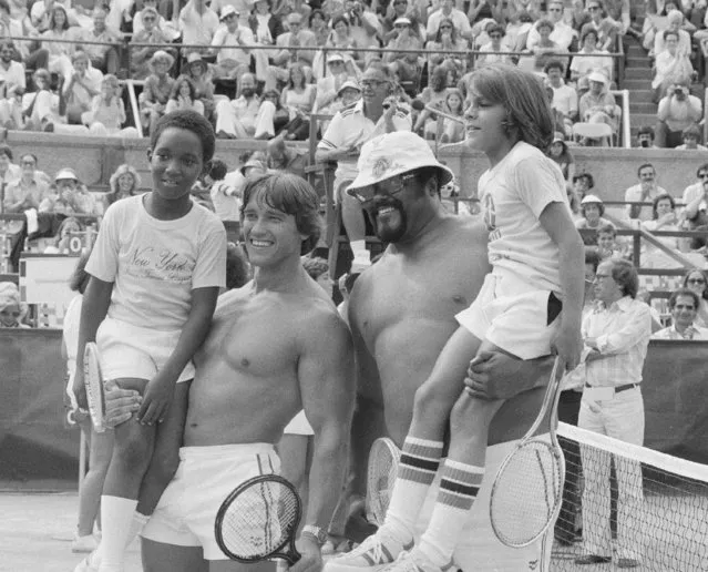 Actor and bodybuilder Arnold Schwarzenegger, second from left, and football player Rosey Grier, third from left, hold up their young opponents, left to right, Wesley Dixon, 10, and Robert Sanchez, 11, both of New Rochelle, at the RFK Celebrity Tennis Tournament in New York, Aug. 27, 1977. (Photo by Marty Lederhandler/AP Photo)