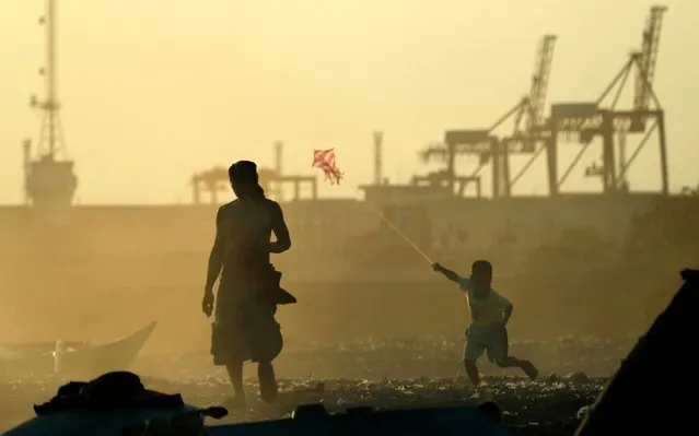 A Filipino boy flies a kite along the Manila bay on the eve of World Earth day, Philippines, 21 April 2020. According to reports, the rehabilitation of the murky water of Manila Bay put on hold as the Philippine government engulfed in public health response to the spread of the deadly coronavirus COVID-19 crisis. (Photo by Francis R. Malasig/EPA/EFE/Rex Features/Shutterstock)