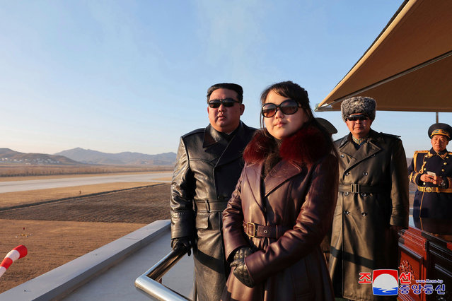 This picture taken on November 30, 2023 and released from North Korea's official Korean Central News Agency (KCNA) via KNS on December 1, 2023 shows North Korea's leader Kim Jong Un (L) and his daughter (C) observing an air festival during a visit with the 1st Air Force Division Flying Regiment of the Korean People's Army to commemorate Air Day, at an unknown location. (Photo by KCNA via KNS/AFP Photo)