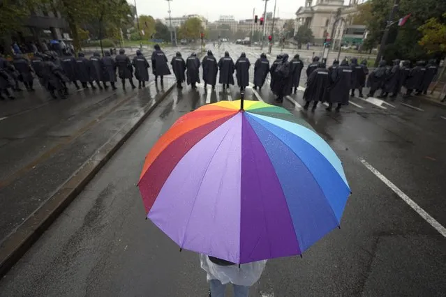 Serbian riot policemen line up to prevent anti-gay protesters from clashing with participants in the European LGBTQ pride march march in Belgrade, Serbia, Saturday, September 17, 2022. Amid mounting tensions, police were deployed Saturday in downtown Belgrade where a Pride march was expected to be held despite threats from anti-gay groups and an official earlier ban. (Photo by Darko Vojinovic/AP Photo)