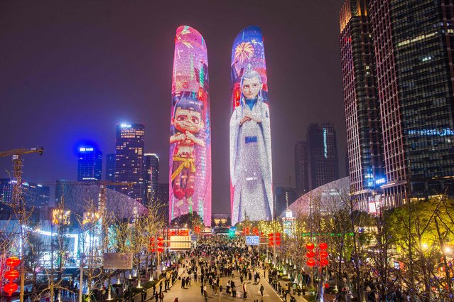 Buildings are lit up with characters from the movie “Ne Zha 2” in Chengdu, in China's southwest Sichuan province on February 12, 2025. Animated Chinese blockbuster “Ne Zha 2”, based on traditional mythology, has smashed multiple box office records on its way to becoming the country's most successful movie ever. (Photo by AFP Photo/China Stringer Network)