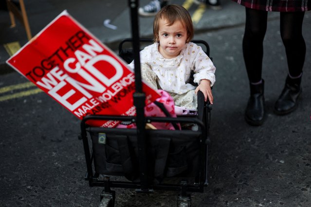 Bella, 3, sits inside a cart, on the day of the Million Women Rise march, during the International Women's Day, in London, Britain, on March 8, 2025. (Photo by Hannah McKay/Reuters)