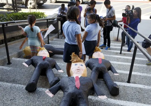 US-born children of immigrants drag Donald Trump pinatas down stairs as they encourage Latinos to register to vote against the US Republican Presidential nominee in Norwalk, California, USA, 31 August 2016. Trump has made numerous controversial remarks about Mexican immigrants during his campaign rallies, and has stated his intention to build a wall on the border between the United States and Mexico in order to prohibit potential undocumented immigrants from coming into the United States. (Photo by Eugene Garcia/EPA)