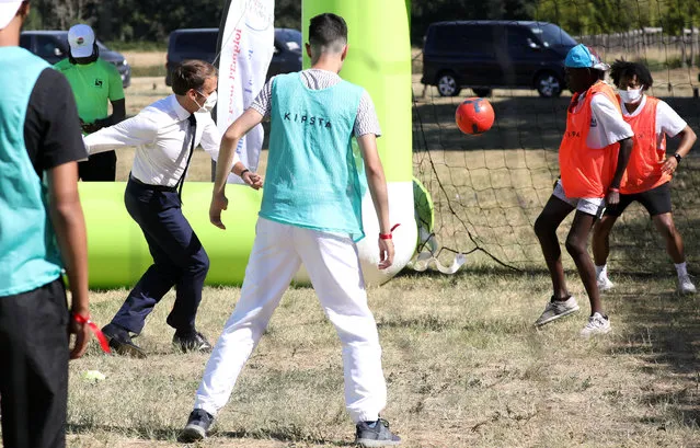 French President Emmanuel Macron plays football with youth taking part in a “learning holidays” summer camp, on July 22, 2020 at Chambord castle, during a visit on the theme of the “learning holidays”. (Photo by Stephane Lemouton/Pool via SIPA Press)