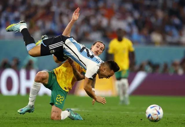 Lautaro Martinez (L) fights for the ball with Australia's midfielder #22 Jackson Irvine during the Qatar 2022 World Cup round of 16 football match between Argentina and Australia at the Ahmad Bin Ali Stadium in Al-Rayyan, west of Doha on December 3, 2022. (Photo by Kai Pfaffenbach/Reuters)