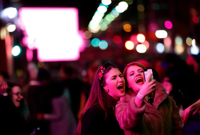 Revellers enjoy themselves during Hogmanay celebrations in Edinburgh, Scotland on December 31, 2017. (Photo by Russell Cheyne/Reuters)