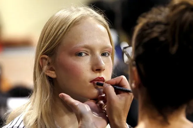 A model has her makeup done backstage before designer Hussein Chalayan Spring/Summer 2016 women's ready-to-wear collection show during the Fashion Week in Paris, France, October 2, 2015. (Photo by Charles Platiau/Reuters)