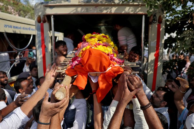 People load the body of Smit Parmar, who was killed in a suspected militant attack near Pahalgam in south Kashmir, into a hearse for his last rites in Bhavnagar, India, on April 24, 2025. (Photo by Amit Dave/Reuters)