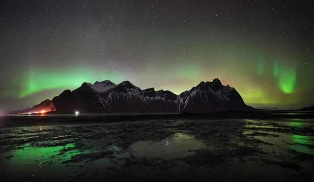 The northern lights, or the aurora borealis, created from a collision between electrically charged particles from the sun that enter the atmosphere of the earth where the particles are redirected by the earth's magnetic field towards the poles, displays over the Vestrahorn mountain in south-east Iceland, noted for its two distinctive peaks and proximity to the Jokulsarlon glacier lagoon and East Fjords on Thursday, March 3, 2022. (Photo by Owen Humphreys/PA Images via Getty Images)