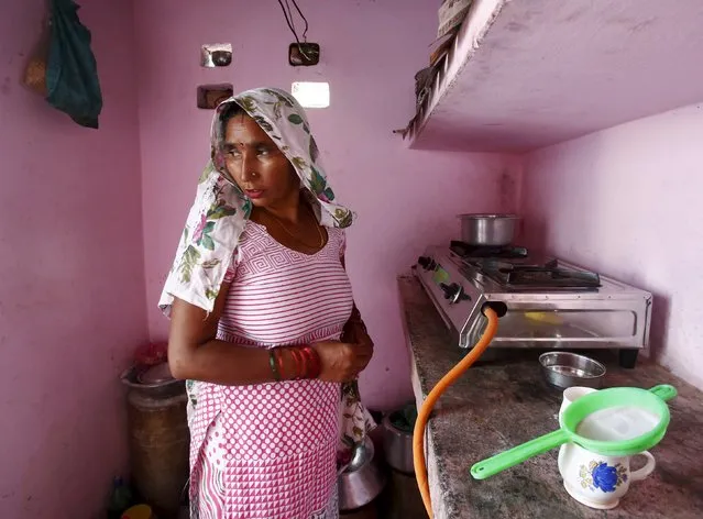 Munesh Nagar, a housewife, cooks on a stove using a Liquefied Petroleum Gas (LPG) cylinder in her kitchen at Dujana village in Noida, on the outskirts of New Delhi October 7, 2015. Liquefied Petroleum Gas, long a niche product used by the poor to cook and the rich to barbecue, has become a rare bright spot amid a broad commodities rout, riding on the wave of strong economic growth in India and parts of Southeast Asia. (Photo by Anindito Mukherjee/Reuters)