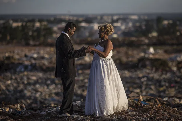 Deoclides Nascimento Brito (L) and Valdineide dos Santos Teixeira (R), both works as “catadores de lixo” or recyclable material collectors, get married at “Lixao da Estrutural”, the biggest garbage dump in Latin America, in Brasilia, Brazil, 18 January 2018. The dump, which receives 1,800 tons of waste every day, will close its doors on 20 January. (Photo by Andre Coelho/EPA/EFE)