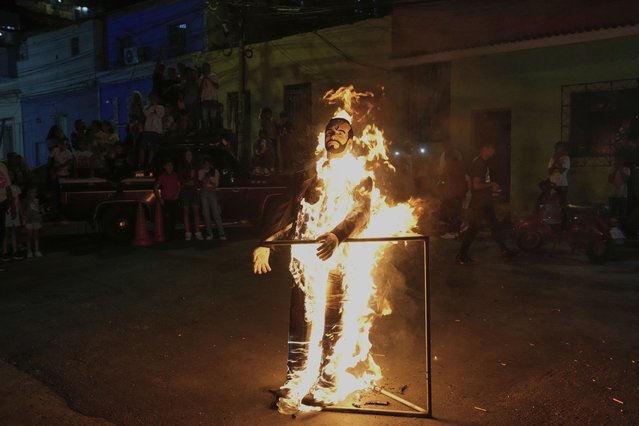 An effigy representing Judas Iscariot and El Salvador's President Nayib Bukele burns as Easter tradition in different communities in Caracas, Venezuela, Sunday, April 20, 2025. (Photo by Ariana Cubillos/AP Photo)