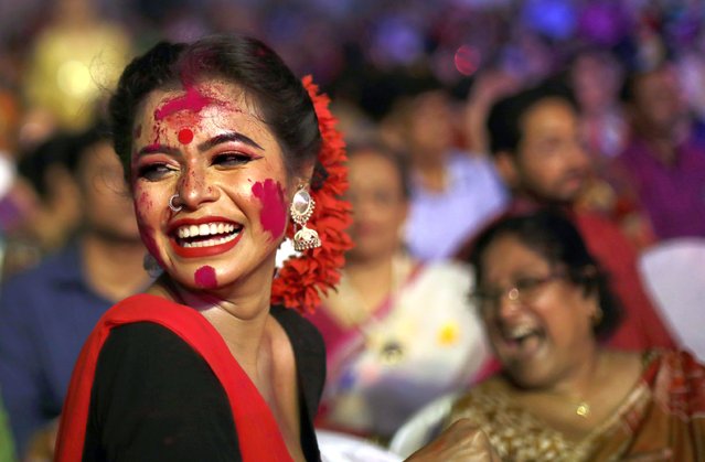 Students of Rabindrabharati University apply colour dust or Gulal on each other during a celebration the festival of colour Holi in Kolkata, Eastern India, 23 March 2024. Holi, also known as the Festival of Colors, is an ancient Hindu festival symbolizing the victory of good over evil and marking the arrival of spring. It is observed with joyful gatherings during which revelers cover each other in colored powders. (Photo by Piyal Adhikary/EPA/EFE)
