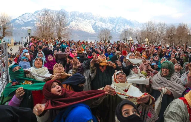Muslim women react as a priest (not pictured) displays a holy relic believed to be a whisker from Prophet Muhammad's beard, at Hazratbal Shrine in Srinagar, India, 15 January 2023. The event was part of special prayers commemorating the death anniversary of the first Caliph of Islam, Abu Bakr Siddiq. (Photo by Farooq Khan/EPA/EFE)