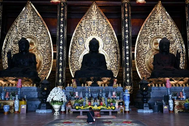 This photograph taken on January 7, 2023 shows a woman praying at Tam Chuc Pagoda in Ha Nam province. (Photo by Nhac Nguyen/AFP Photo)