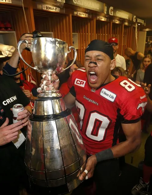 Calgary Stampeders Eric Rogers celebrates in the locker room with the Grey Cup after the Stampeders defeated the Hamilton Tiger Cats in the CFL's 102nd Grey Cup football championship in Vancouver, British Columbia, November 30, 2014. (Photo by Todd Korol/Reuters)