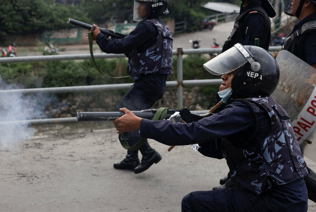 A riot police officer fires teargas towards the demonstrators during a protest against corruption and the government's decision to block several social media platforms, in Kathmandu, Nepal on September 8, 2025. (Photo by Navesh Chitrakar/Reuters)