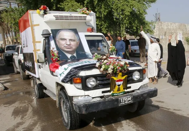 The funeral procession of Ahmed Chalabi moves through Baghdad, Iraq, November 4, 2015. Chalabi, the smooth-talking Iraqi politician who pushed Washington to invade Iraq in 2003 with discredited information on Saddam Hussein's military capabilities, died on Tuesday of an apparent heart attack. (Photo by Khalid al-Mousily/Reuters)