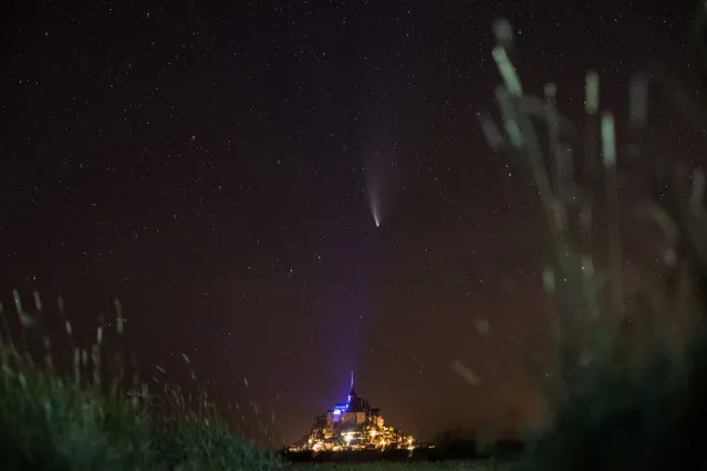This long-exposure picture taken late on July 22, 2020, shows a view of the Comet NEOWISE (C/2020 F3) in the sky over the Mont-Saint-Michel, western France. The Comet C/2020 F3 was discovered March 27, 2020, by NEOWISE, the Near Earth Object Wide-field Infrared Survey Explorer, which is a space telescope launched by NASA in 2009. (Photo by Loic Venance/AFP Photo)
